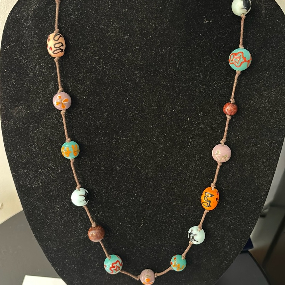 Glass hand painted marble necklace on a knotted cord 32”